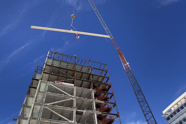 The final beam is raised into place during a topping-out ceremony for the Federal Justice Tower in downtown Las Vegas Wednesday, March 27, 2013. The new 11-story tower, just to the south of the Lloyd D. George Federal Courthouse on Las Vegas Boulevard, will house the executive and administrative offices of the Department of Homeland Security, U.S. Immigration, U.S. Attorney's Office for the District of Nevada, the Department of Labor Office of Inspector General and the Federal Protective Services.