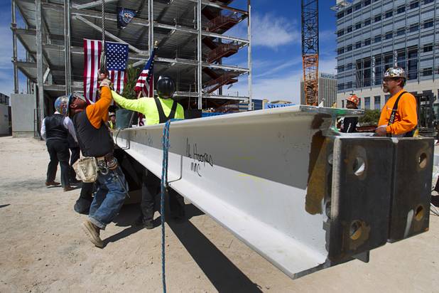 Ironworkers prepare the final beam to be lifted by a crane during a topping-out ceremony for the Federal Justice Tower in downtown Las Vegas Wednesday, March 27, 2013. The new 11-story tower, just to the south of the Lloyd D. George Federal Courthouse on Las Vegas Boulevard, will house the executive and administrative offices of the Department of Homeland Security, U.S. Immigration, U.S. Attorney's Office for the District of Nevada, the Department of Labor Office of Inspector General and the Federal Protective Services.