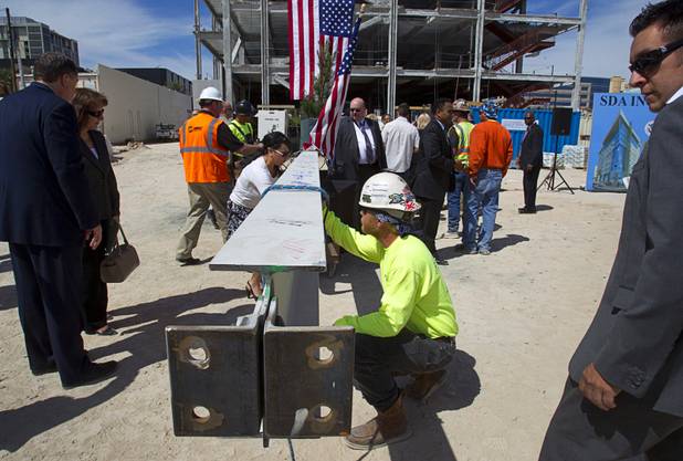 Ironworkers, guests and others involved the construction project sign a final beam during a topping-out ceremony for the Federal Justice Tower in downtown Las Vegas Wednesday, March 27, 2013. The new 11-story tower, just to the south of the Lloyd D. George Federal Courthouse on Las Vegas Boulevard, will house the executive and administrative offices of the Department of Homeland Security, U.S. Immigration, U.S. Attorney's Office for the District of Nevada, the Department of Labor Office of Inspector General and the Federal Protective Services.