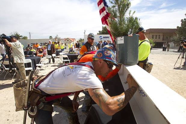 Ironworker Mike Dyke signs the final steel beam during a topping-out ceremony for the Federal Justice Tower in downtown Las Vegas Wednesday, March 27, 2013. The new 11-story tower, just to the south of the Lloyd D. George Federal Courthouse on Las Vegas Boulevard, will house the executive and administrative offices of the Department of Homeland Security, U.S. Immigration, U.S. Attorney's Office for the District of Nevada, the Department of Labor Office of Inspector General and the Federal Protective Services.