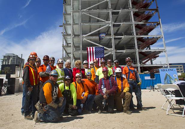 Las Vegas Mayor Carolyn Goodman, center, poses with ironworkers following a topping-out ceremony for the Federal Justice Tower in downtown Las Vegas Wednesday, March 27, 2013. The new 11-story tower, just to the south of the Lloyd D. George Federal Courthouse on Las Vegas Boulevard, will house the executive and administrative offices of the Department of Homeland Security, U.S. Immigration, U.S. Attorney's Office for the District of Nevada, the Department of Labor Office of Inspector General and the Federal Protective Services.