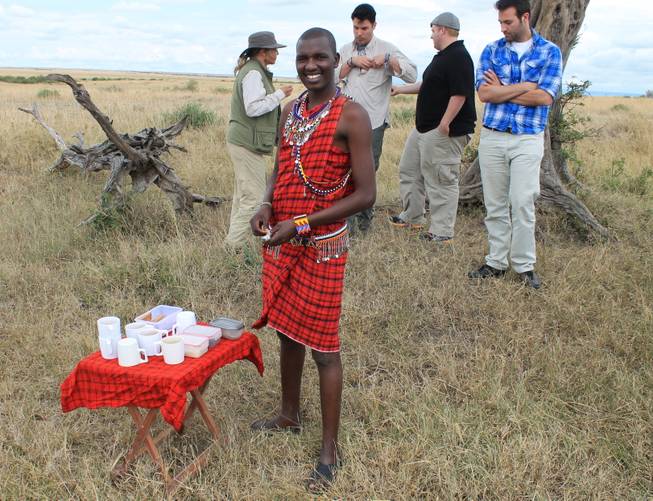 Porini Mara Camp guide Geoffrey Risa Ketere readies for a tea break with the Moreno brothers and traveling companion Peggy Armstrong in the Ol Kinyei Conservancy in southeastern Kenya. 