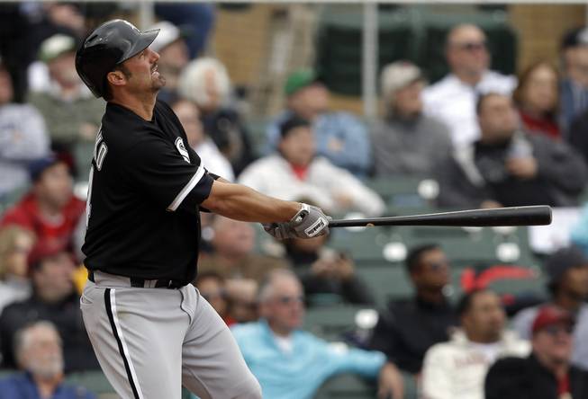 Chicago White Sox's Paul Konerko watches his three-run home run against the Arizona Diamondbacks during the fifth inning of an exhibition spring training baseball game on Saturday, March 9, 2013 in Scottsdale, Ariz.