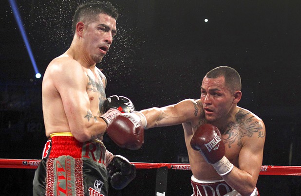 Brandon Rios, left, takes a punch from Mike Alvarado during a super lightweight bout for an interim 140lb. WBO title at the Mandalay Bay Events Center Saturday, March 30, 2013. The fight was a rematch to a Oct. 13, 2012 fight  which Rios won.