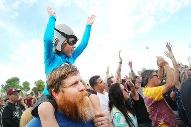 Degan Marvick sits on his father Drew Marvick’s shoulders during The Aquabats set during the Extreme Thing Sports & Music Festival at Desert Breeze Park.Saturday, March 30, 2013.