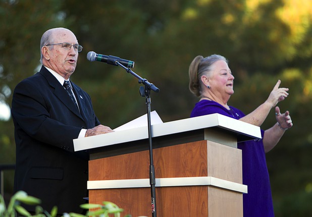 Reverend Leo Wood gives a spiritual message as Terresa Smart signs during the 28th annual Easter sunrise service at Palm Eastern Mortuary and Cemetery Sunday, March 31, 2013.