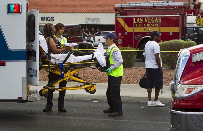 A woman is loaded into an ambulance outside the Egg and I restaurant on West Sahara Avenue Monday April 1, 2013. As many as 10 people were injured when a Lexus sedan left the roadway and crashed into the restaurant.