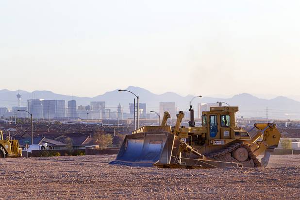 Las Vegas Strip casinos are seen in the background as earth movers prepare the desert for new homes at the Mountain's Edge master planned community in the southwest west part of the Las Vegas Valley April 1, 2013.
