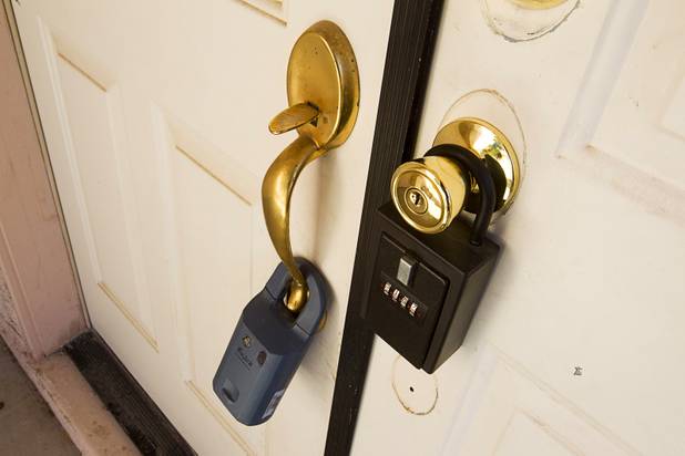 Key boxes are shown at vacant home in North Las Vegas April 2, 2013. A neighbor said it has been vacant for about six months. (1513  Splinter Rock, North Las Vegas)