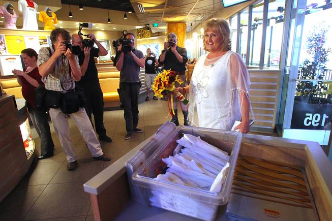 Nancy Levandowski makes her entrance into the Denny's restaurant on Fremont Street for her wedding to Steve Keller Wednesday, April 3, 2013.