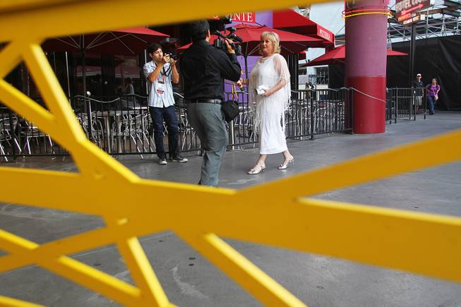 Nancy Levandowski is followed by cameras as she makes her way to the Denny's restaurant on Fremont Street for her wedding ceremony with Steve Keller Wednesday, April 3, 2013.