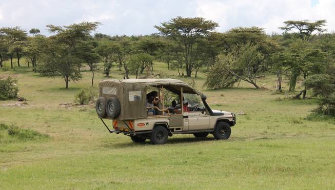 A Toyota Land Cruiser -- the chosen vehicle at Porini Mara Camps -- cruises through Ol Kinyei Conservancy in southeastern Kenya.
