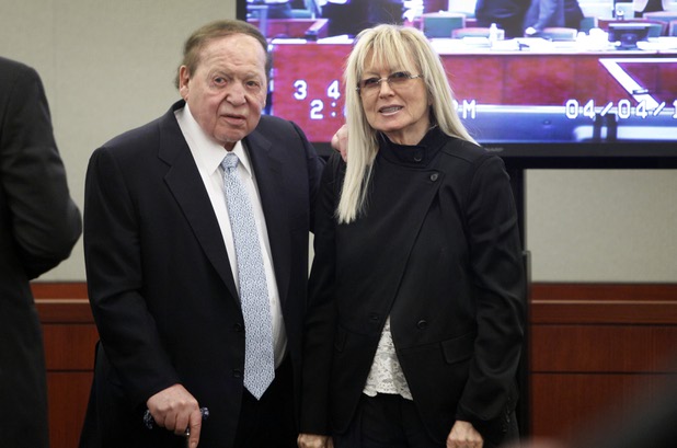 Las Vegas Sands Chairman and CEO Sheldon Adelson is accompanied by his wife Miriam as he enters the courtroom after a break at the Regional Justice Center Thursday, April 4, 2013. Hong Kong businessman Richard Suen is suing the Las Vegas Sands saying he is owed millions of dollars in an agreement in which he helped Sands secure its gaming license in Macau a decade ago.