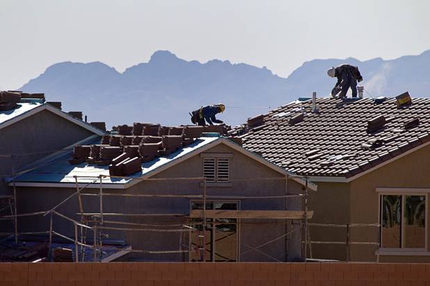 Roofers work on new homes at a residential construction site in the west side of the Las Vegas Valley in Las Vegas, April 5, 2013.