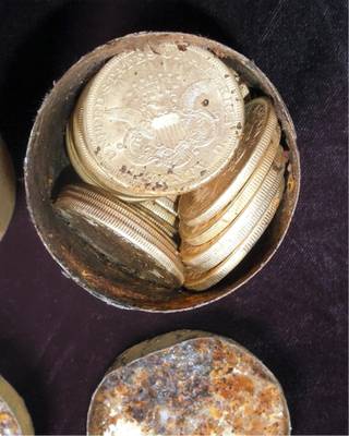 This image provided by the Saddle Ridge Hoard discoverers via Kagin's, Inc., shows one of the six decaying metal canisters filled with 1800s-era U.S. gold coins unearthed in California by two people who want to remain anonymous.  The value of the 