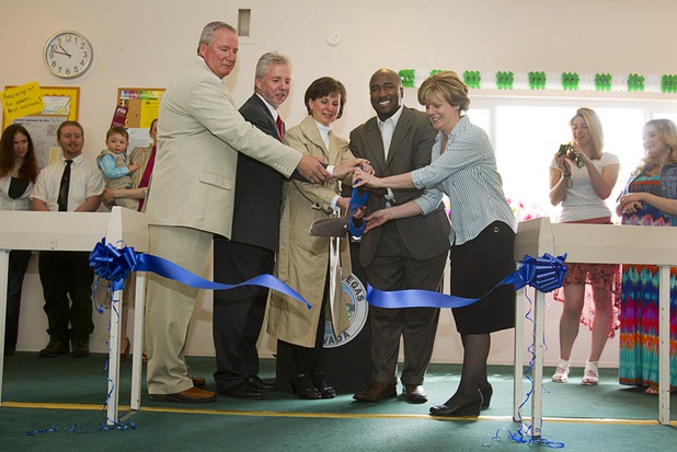 Las Vegas City Councilman Ricki Y. Barlow, center, and children of Doris Stoehr, cut a ribbon during a crosswalk dedication at the Las Vegas Manor senior complex on North Decatur Boulevard Monday, April 8, 2013. From left are: Brian Stoehr, Pat Stoehr, Barlow, and Pat's wife Denise. The crosswalk is dedicated to Doris Stoehr, a resident of the complex, who was killed crossing the boulevard in February.