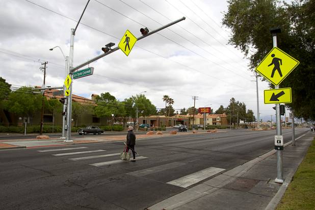 A woman crosses the street at a new crosswalk on North Decatur Boulevard Monday, April 8, 2013. The crosswalk is dedicated to Doris Stoehr, a resident of Las Vegas Manor senior complex, who was killed crossing the boulevard in February.