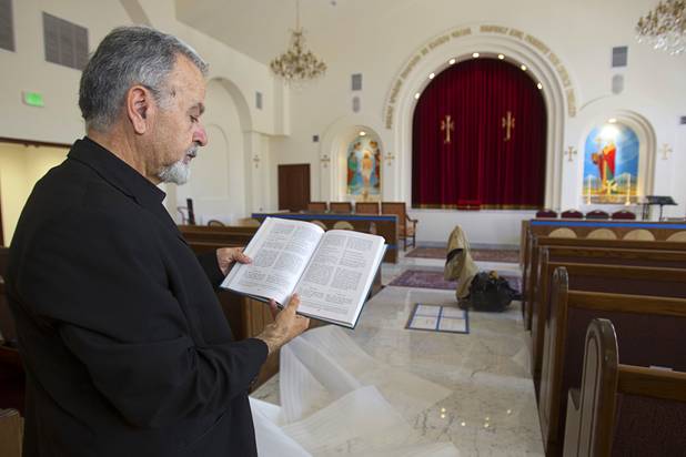 Archpriest Father Avedis Torossian holds a prayer book in the sanctuary of St. Garabed Armenian Apostolic Church of Las Vegas on East Desert Inn Road Tuesday, April 9, 2013. The church is nearing completion and is scheduled to be consecrated this weekend by Western Prelate Archbishop Moushegh Mardirossian.
