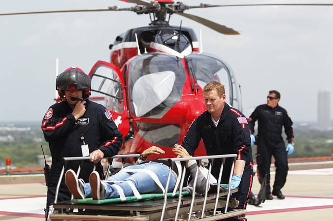 Life Flight personnel rush a victim wounded in a stabbing attack on the Lone Star community college system's Cypress, Texas, campus into Memorial Hermann Hospital Tuesday, April 9, 2013, in Houston. The Harris County Sheriff's department confirmed at least 11 people wounded and that authorities have one suspect in custody.