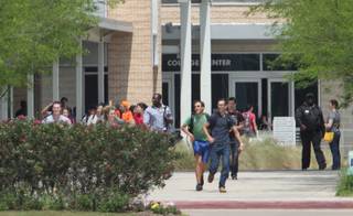 Students run from the Lone Star College's Cypress-Fairbanks campus Tuesday, April 9, 2013, in Cypress, Texas.At least 14 people were hurt in a stabbing at the campus Tuesday.  