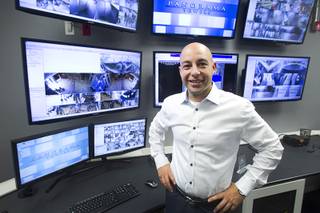 Christian Petrou, CEO and founder of Rvnue Technologies, poses in the Security Operations Center before a hi-tech security tour of the Panorama Towers Wednesday, April 10, 2013. Petrou designed the security system at the condo towers. The tour was held in conjunction with the International Security Conference & Exposition (ISC West)  taking place at the Sands Expo Center.
