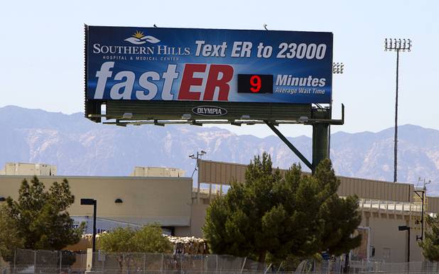 A billboard near the 215 Beltway and Eastern Avenue advertises a short wait time for emergency room care at Southern Hills Hospital on Thursday, April 11, 2013. 