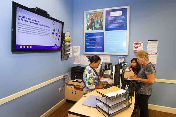 Rina Silva, a medical assistant, helps Julia Gonzales with an appointment at a Southwest Medical Associates clinic inside a Walmart, 300 E. Lake Mead Pkwy., in Henderson Thursday, April 11, 2013.  With Gonzales is her granddaughter Joey Mestas, 7.