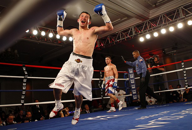 Bahodir "Baha" Mamadjonov of Uzbekistan celebrates after beating Angelo "La Cobra" Santana of Cuba in a WBA lightweight bout at the Treasure Island Friday, April 12, 2013. Mamadjonov won the fight with a ninth-round TKO. Referee Kenny Bayless is at right.