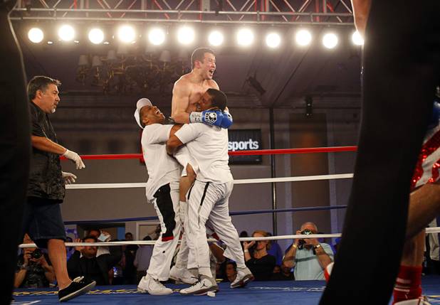 Bahodir "Baha" Mamadjonov of Uzbekistan celebrates with members of his camp after beating Angelo "La Cobra" Santana of Cuba in a WBA lightweight bout at the Treasure Island Friday, April 12, 2013. Mamadjonov won the fight with a ninth-round TKO.