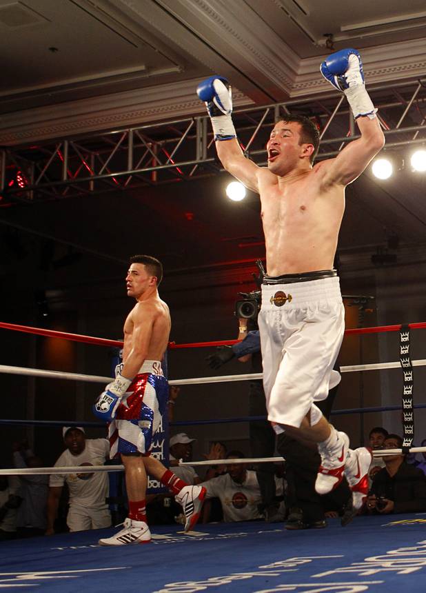 Bahodir "Baha" Mamadjonov of Uzbekistan leaps in celebration after beating Angelo "La Cobra" Santanaa of Cuba in a WBA lightweight bout at the Treasure Island Friday, April 12, 2013. Mamadjonov won the fight with a ninth-round TKO. Referee Kenny Bayless is at right.