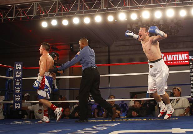 Bahodir "Baha" Mamadjonov of Uzbekistan leaps in celebration after beating Angelo "La Cobra" Santanaa of Cuba in a WBA lightweight bout at the Treasure Island Friday, April 12, 2013. Mamadjonov won the fight with a ninth-round TKO. Referee Kenny Bayless is at right.