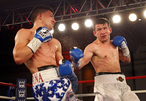 Angelo "La Cobra" Santana, left, of Cuba and Bahodir "Baha" Mamadjonov of Uzbekistan battle during a WBA lightweight bout at the Treasure Island Friday, April 12, 2013.