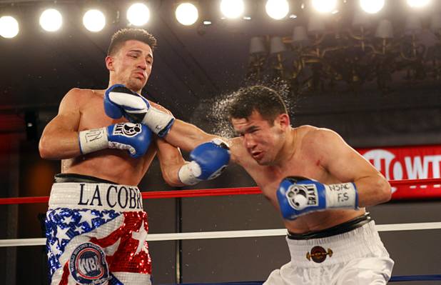 Angelo "La Cobra" Santana, left, of Cuba lands a punch on Bahodir "Baha" Mamadjonov of Uzbekistan during a WBA lightweight bout at the Treasure Island Friday, April 12, 2013.