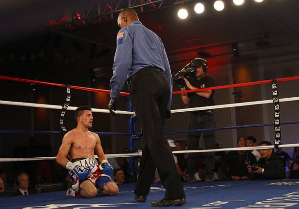Angelo "La Cobra" Santana of Cuba recovers after a knockdown in his fight against Bahodir "Baha" Mamadjonov of Uzbekistan during a WBA lightweight bout at the Treasure Island Friday, April 12, 2013.