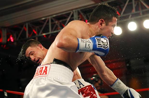 Angelo "La Cobra" Santana, left, of Cuba and Bahodir "Baha" Mamadjonov of Uzbekistan battle during a WBA lightweight bout at the Treasure Island Friday, April 12, 2013.