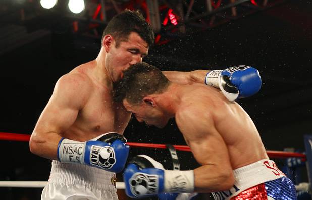 Bahodir "Baha" Mamadjonov, left, of Uzbekistan gets hit by an accidental head butt from  Angelo "La Cobra" Santana of Cuba during a WBA lightweight bout at the Treasure Island Friday, April 12, 2013.