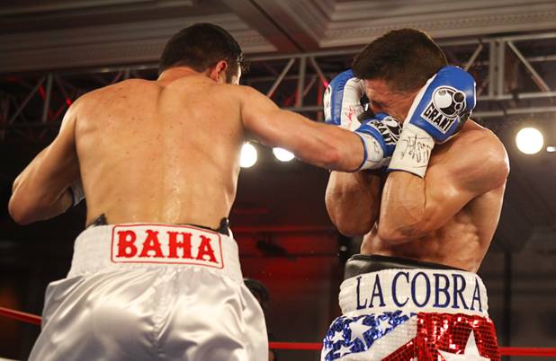 Bahodir "Baha" Mamadjonov, left, of Uzbekistan lands a punch on Angelo "La Cobra" Santana of Cuba during a WBA lightweight bout at the Treasure Island Friday, April 12, 2013.