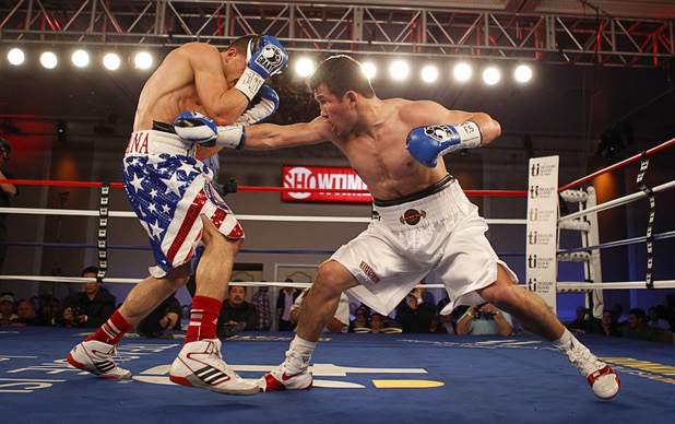 Bahodir "Baha" Mamadjonov, right, of Uzbekistan punches Angelo "La Cobra" Santana of Cuba during a WBA lightweight bout at the Treasure Island Friday, April 12, 2013.