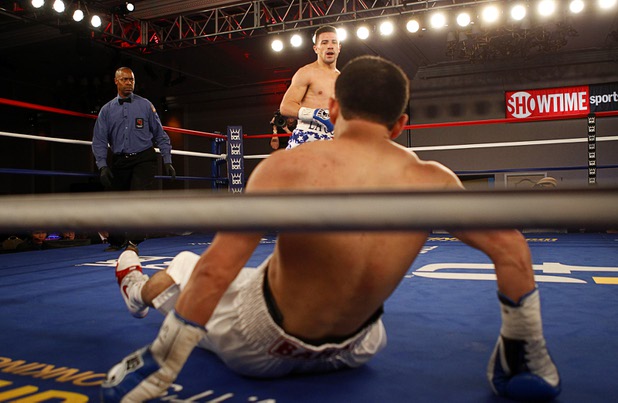 Bahodir "Baha" Mamadjonov of Uzbekistan is knocked down by Angelo "La Cobra" Santana of Cuba during a WBA lightweight bout at the Treasure Island Friday, April 12, 2013.