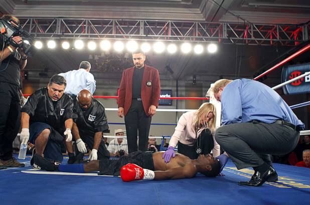 Ringside physician Vicki Mazzorana checks on Jeremy "Hollywood" Bryan of Paterson, N.J. after he was knocked out by Amir "Little Master" Imam of Albany, N.Y. during a super lightweight attraction at the Treasure Island Friday, April 12, 2013. Imam knocked out Bray in the second round.