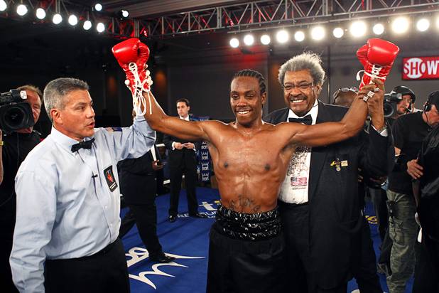 Amir "Little Master" Imam of Albany, N.Y. poses with referee Russell Mora and boxing promoter Don King after knocking out Jeremy "Hollywood" Bryan of Paterson, N.J. during a super lightweight attraction at the Treasure Island Friday, April 12, 2013. Imam knocked out Bray in the second round.