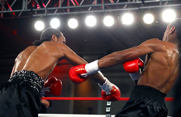 Jeremy "Hollywood" Bryan, right, of Paterson, N.J. falls to the canvas after being hit by Amir "Little Master" Imam of Albany, N.Y. during a super lightweight attraction at the Treasure Island Friday, April 12, 2013. Imam knocked out Bray in the second round.