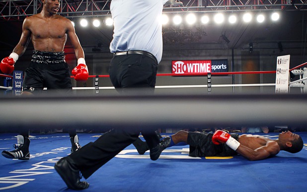 Jeremy "Hollywood" Bryan, right, of Paterson, N.J. falls to the canvas after being hit by Amir "Little Master" Imam of Albany, N.Y. during a super lightweight attraction at the Treasure Island Friday, April 12, 2013. Imam knocked out Bray in the second round.