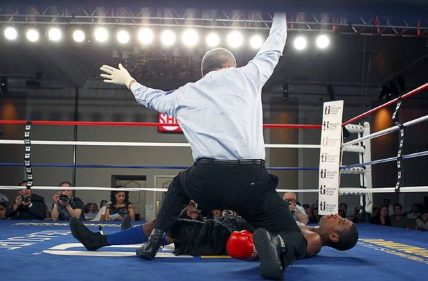 Referee Russell Mora calls an end to the fight after Jeremy "Hollywood" Bryan of Paterson, N.J. is knocked out by Amir "Little Master" Imam of Albany, N.Y. in the second round of a super lightweight attraction at the Treasure Island Friday, April 12, 2013.