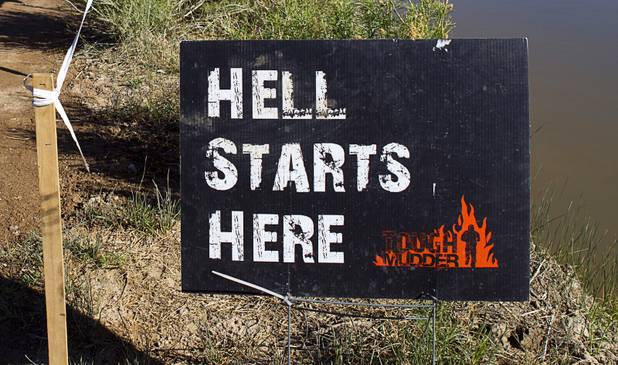 A sign at the beginning of the Tough Mudder course is shown in Beatty, Nev. Sunday, April 14, 2013. Tough Mudder events are hardcore 10-12 mile obstacle courses designed to test all-around strength, stamina, mental grit, and camaraderie.