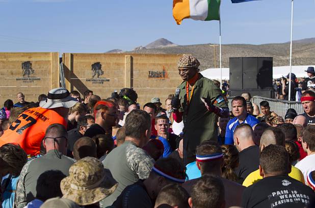 The first wave of competitors gets a pep talk before the start of the Tough Mudder in Beatty, Nev. Sunday, April 14, 2013. Tough Mudder events are hardcore 10-12 mile obstacle courses designed to test all-around strength, stamina, mental grit, and camaraderie.