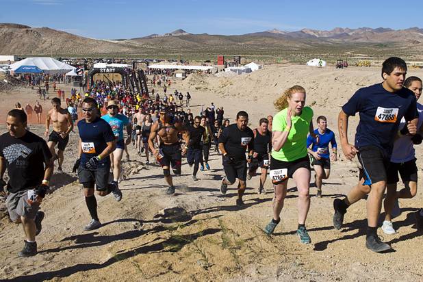 The first wave of competitors head out during the Tough Mudder in Beatty, Nev. Sunday, April 14, 2013. Tough Mudder events are hardcore 10-12 mile obstacle courses designed to test all-around strength, stamina, mental grit, and camaraderie.