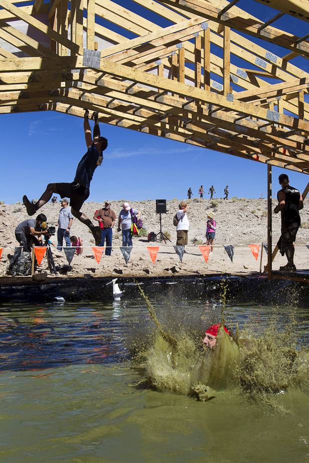 A man falls into the water at the "Funky Monkey" obstacle during the Tough Mudder in Beatty, Nev. Sunday, April 14, 2013. Tough Mudder events are hardcore 10-12 mile obstacle courses designed to test all-around strength, stamina, mental grit, and camaraderie.