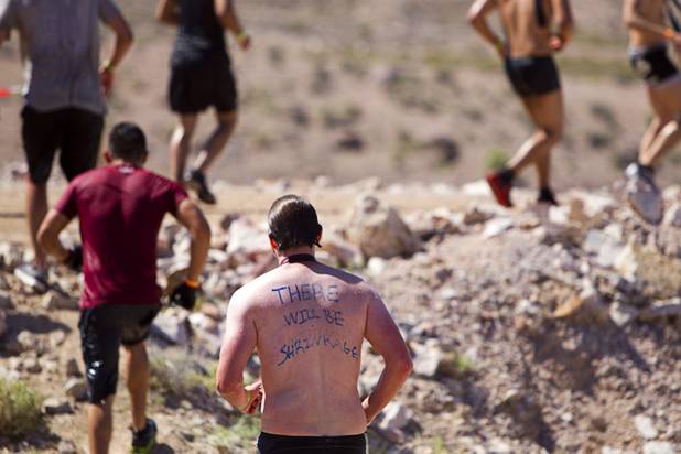Competitors run between obstacles during the Tough Mudder in Beatty, Nev. Sunday, April 14, 2013. Tough Mudder events are hardcore 10-12 mile obstacle courses designed to test all-around strength, stamina, mental grit, and camaraderie.