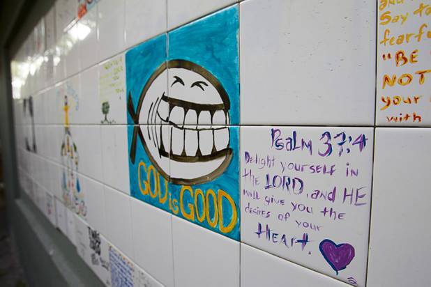 Hand painted tiles are shown on a wall at Casa de Luz, a small church in the Naked City area Monday, April 15, 2013. The church, which currently services about 1,800 area residents with a food pantry, is beginning on a major renovation project.